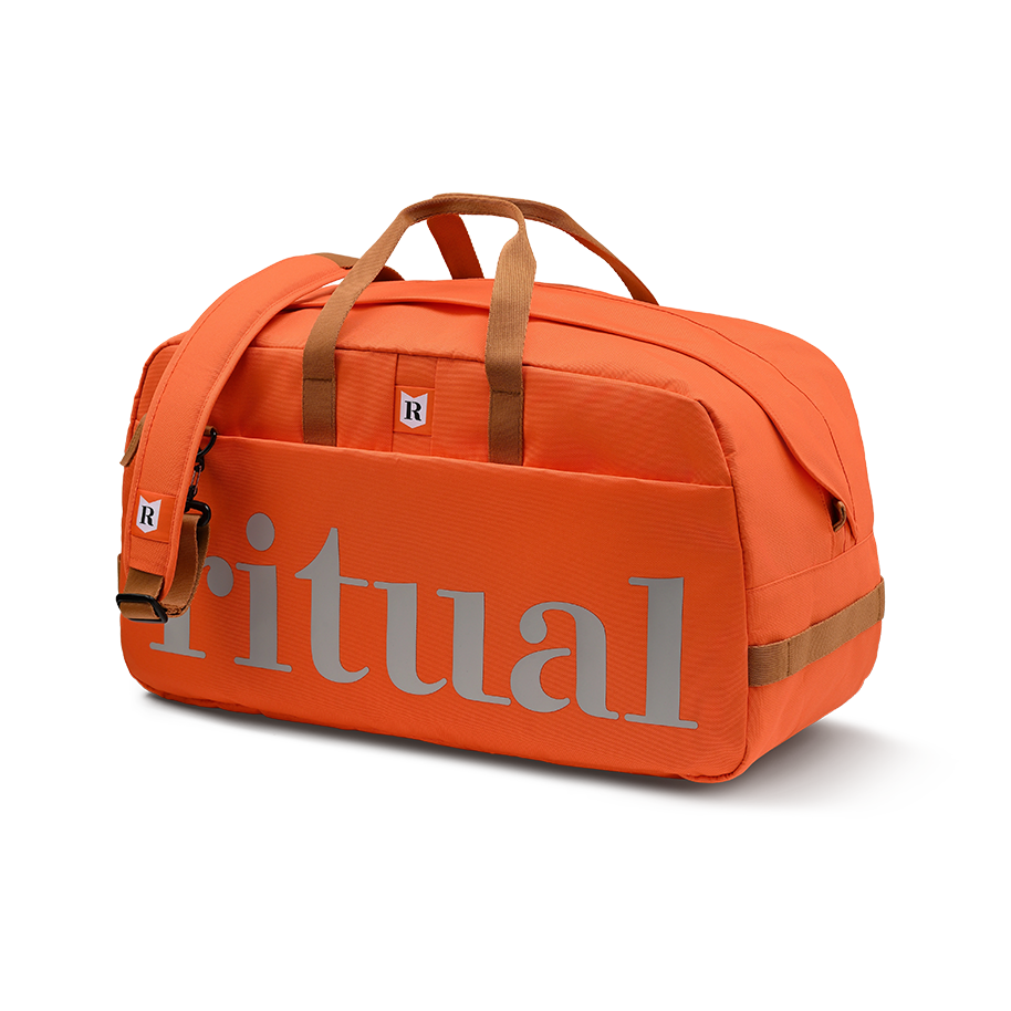 Ritual Calibre hockey duffle bag orange with straps and silver logo, front view