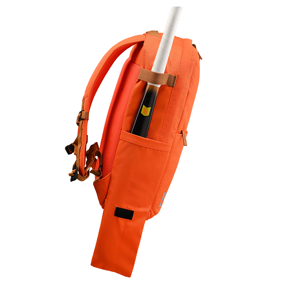 Ritual Covert hockey backpack orange  with a stick left angle