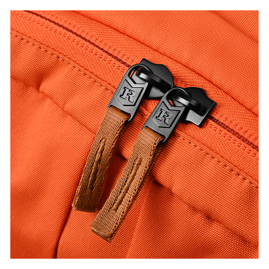 Ritual Covert hockey backpack orange fabric with brown leather handles and black metal clasps
