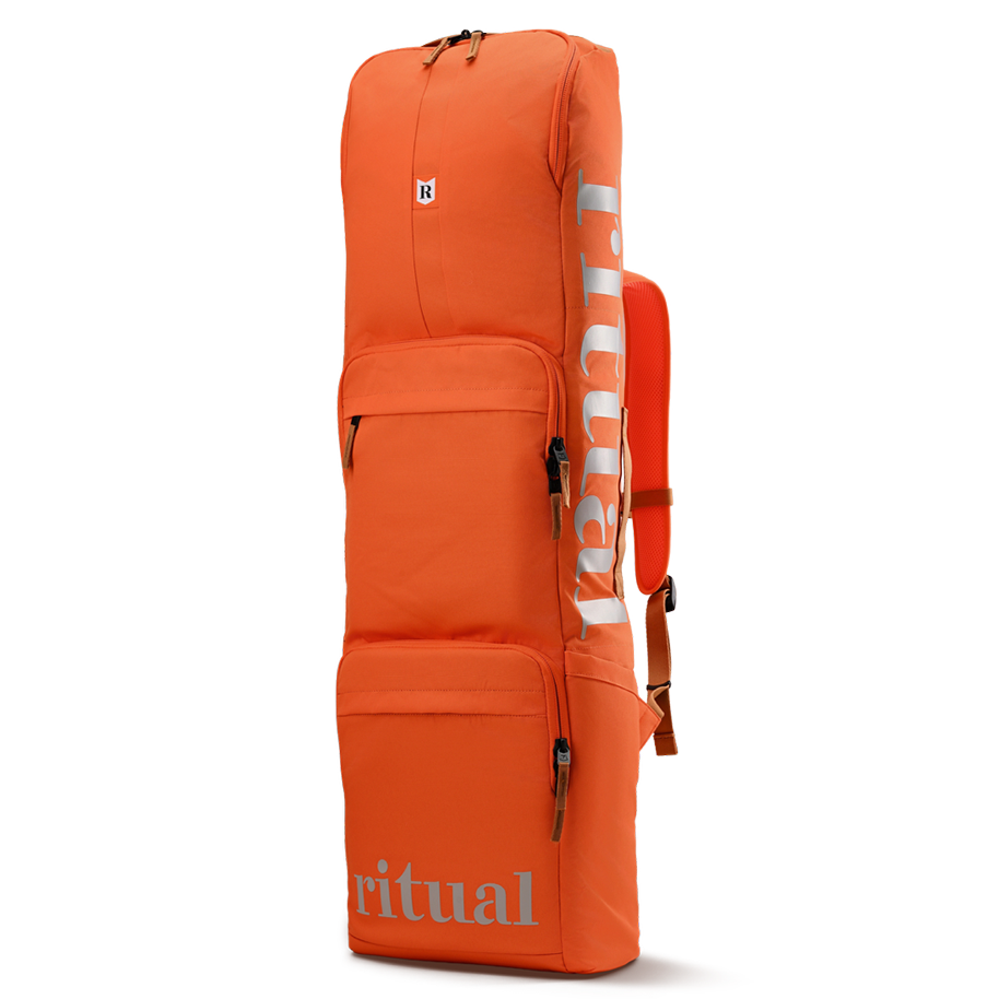 Orange Ritual Hockey backpack with reflective stripes on a white background